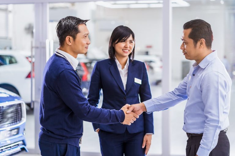 Asian woman sales representative introducing the service to customer, Mechanic leader handshake