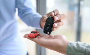 Close-up shot of Sellers handing over car keys to customers,Car sales ideas.