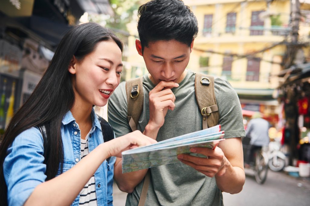 Tourists looking at the directions from map